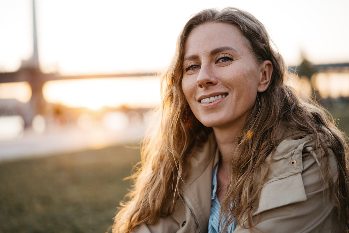 a woman sitting outside and smiling