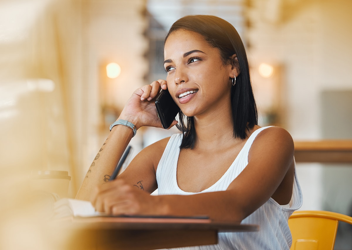 Young adult sitting on steps using a mobile phone