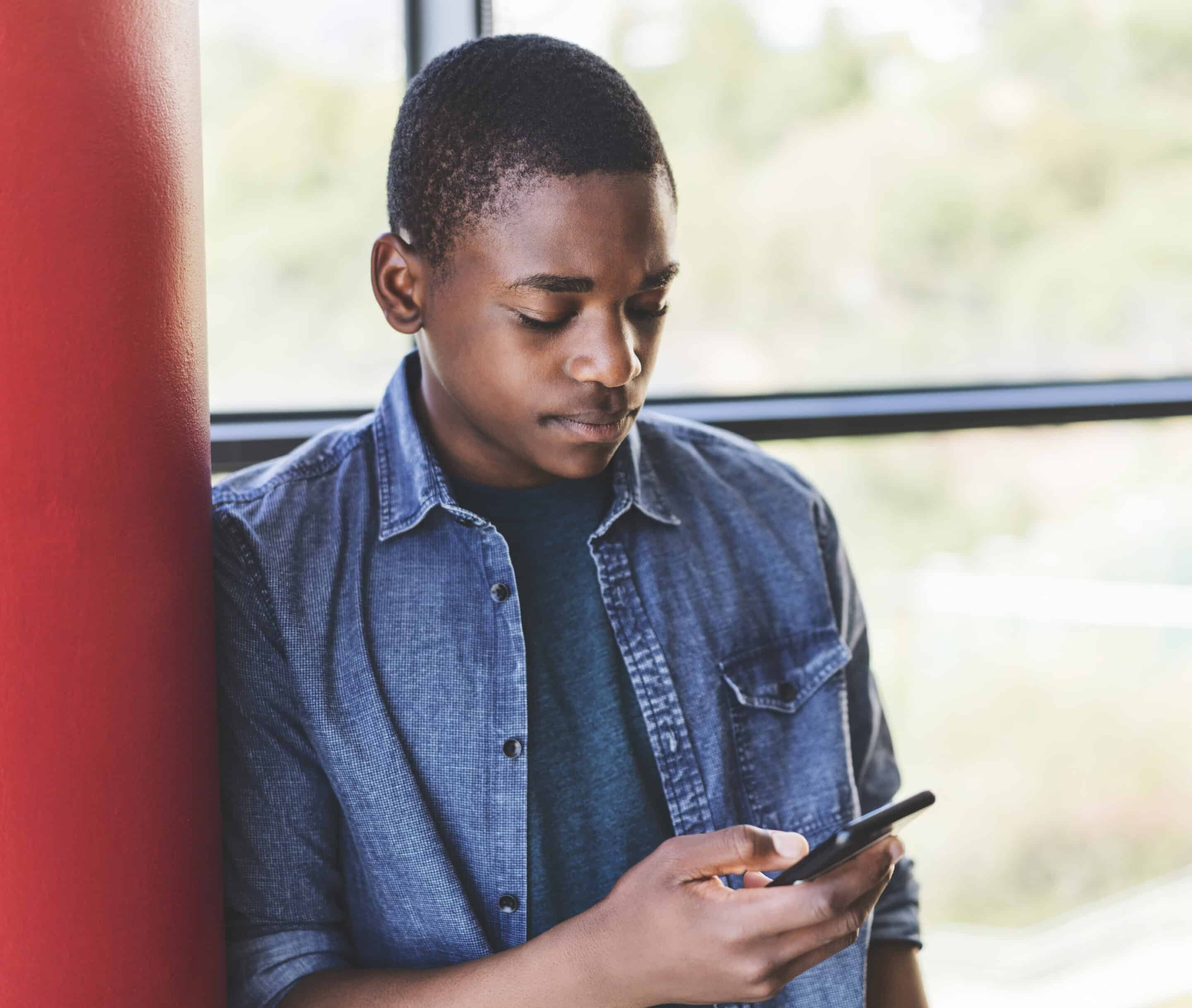 Young adult using a phone while taking a break from class